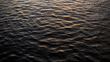 A closeup of a shallow disturbance on water surface