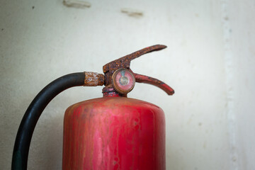 A very old chemical fire extinguisher which rusty handle and dirty pressure gauge. Emergency...
