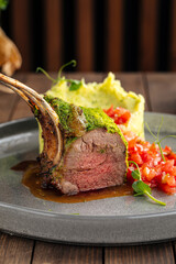 Rack of lamb with mashed potatoes on wooden background