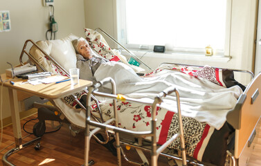 Sick, elderly senior woman in a hospital bed