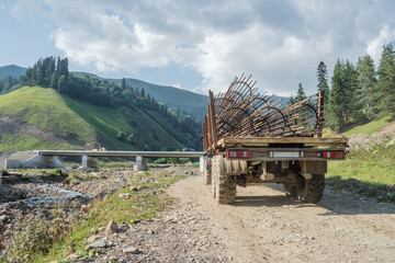 A truck transports a frame made of reinforcement for the construction of the bridge support structures.