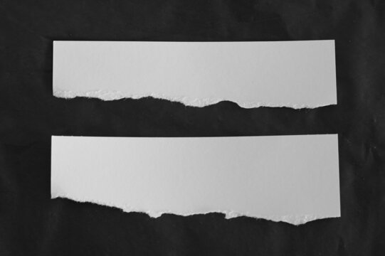 Ripped paper on black background, empty space for text.