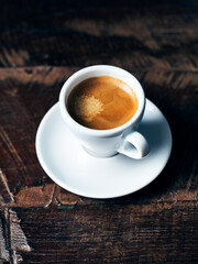 Cup of strong Espresso on rustic wooden background