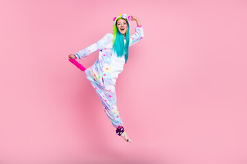 Full length body size view of attractive cheery girl in kigurumi jumping fooling isolated on pink pastel color background