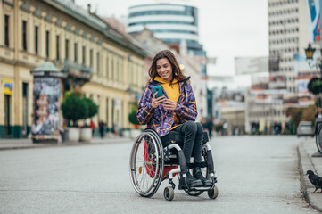 Fototapeta na wymiar Woman with disability using a smartphone while out in the city