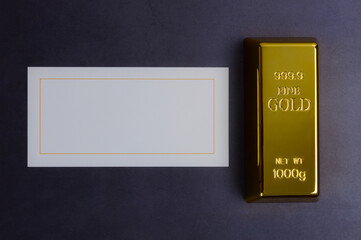 An ingot of gold metal bullion of pure brilliant on a gray textured background.