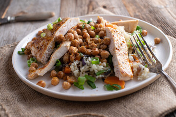 Fried chicken breast with  rice, vegetables and roasted chickpeas