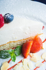Piece of classic cheesecake with strawberries on a plate