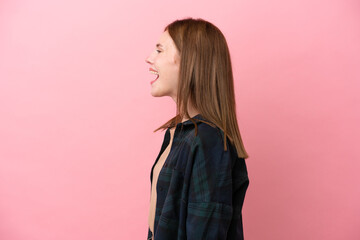 Young English woman isolated on pink background laughing in lateral position