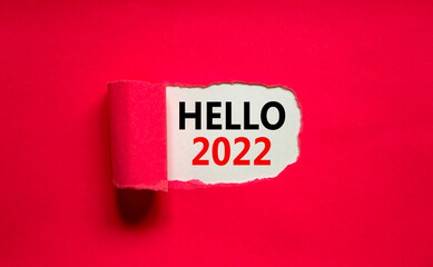 2022 hello new year symbol. Concept words Hello 2022 appearing behind torn pink paper. Beautiful pink background. Business, hello 2022 new year concept, copy space.