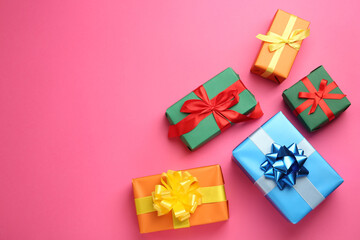 Many colorful gift boxes on pink background, flat lay. Space for text