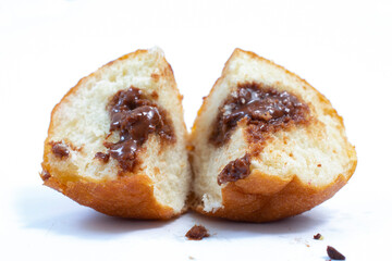 small round donuts with chocolate filling on white background
