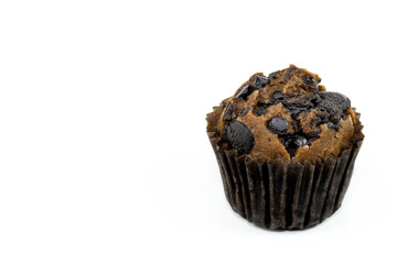 Fresh homemade delicious chocolate muffins in paper cupcake holder isolated on white background. With copy space for texts.