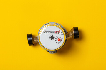 residential water meter on a yellow background