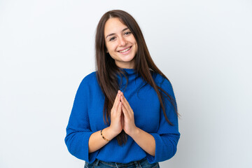 Young Ukrainian woman isolated on white background keeps palm together. Person asks for something