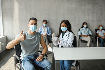 Middle-eastern guy getting vaccinated against coronavirus at clinic