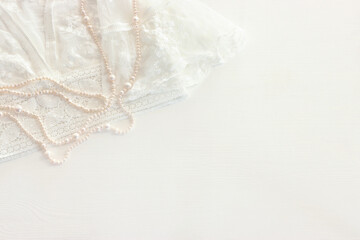 Background of white delicate lace fabric and pearls