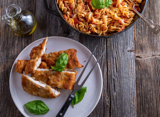 Breaded chicken with pasta and tomato sauce