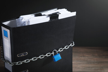 Documents locked with padlock and chains.