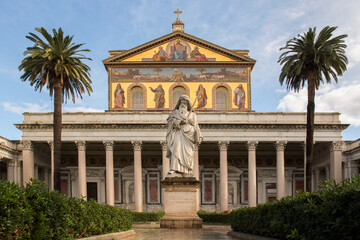Fototapeta na wymiar Exterior of the papal basilica of Saint Paul Outside the Walls in Rome, Italy. The facade above the colonnade is decorated with mosaics made in the 19th century.