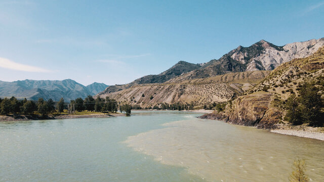 Two rivers collide into one with amazing mountain view. Drone footage