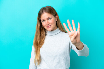 Young blonde woman isolated on blue background happy and counting four with fingers