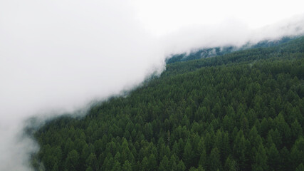 The fog over the hills is approaching. Drone footage
