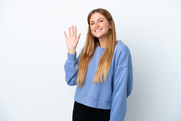 Young blonde woman isolated on white background saluting with hand with happy expression