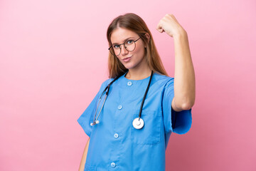 Young surgeon doctor woman isolated on pink background doing strong gesture