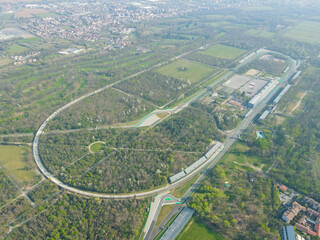 Fototapeta premium Aerial view of The Autodromo Nazionale of Monza, that is a race track located near the city of Monza, north of Milan, in Italy. Drone photography of the circuit in Monza, Lombardia, Brianza.