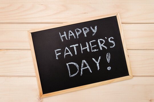 Happy fathers day on chalk board on wooden light backround