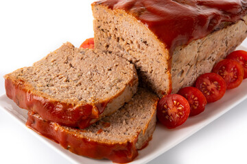 Traditional American meatloaf with ketchup isolated on white background.