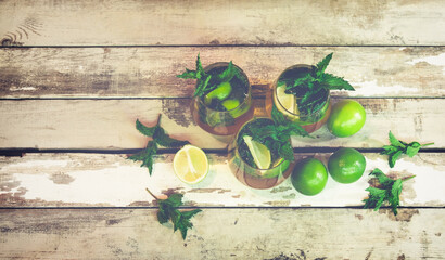 Mojito cocktail with lime and mint. Selective focus. Toned image. Top view.