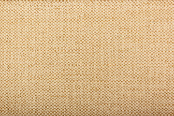 Factory fabric with brown and white threads interspersed. Close-up long and wide texture of natural...