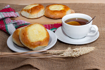 Sweet buns with cottage cheese and a cup of hot tea