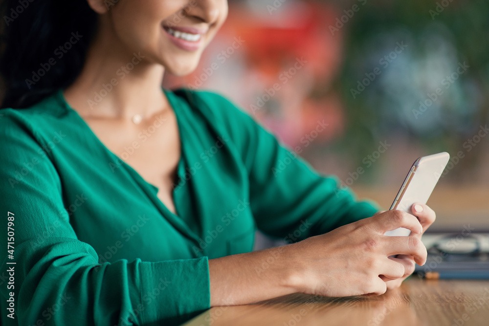 Wall mural unrecognizable young woman using mobile phone at cafe