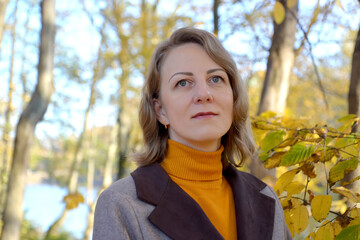 Portrait of a peaceful woman in an autumn park