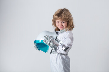 Kid boy exploring space. Portrait of cute kids in space suits holding helmet . Cosmonautics day concept. © Volodymyr