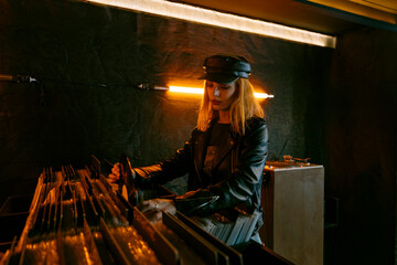 Woman picking vinyl record in store