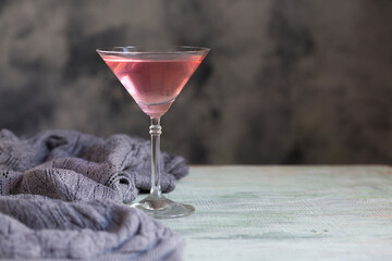 Pink lingonberries  Cocktail , textured background, daylight. copy space