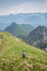 Fototapeta na wymiar Young child boy hiker conquer the peaks of amazing mountain trail Monte Montusel in Friuli-Venezia Giulia, Italy