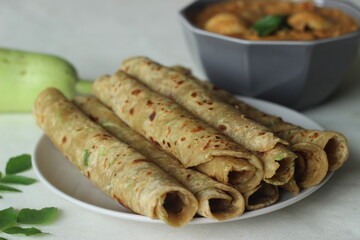Indian flat bread made of whole wheat flour, grated bottle guard, yogurt and spices served with boiled egg curry. Commonly called as lauki paratha and anda curry in India.
