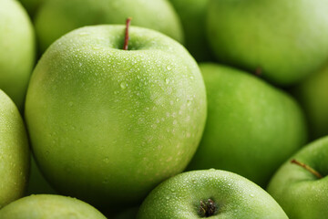 Juicy Green apple close-up with dew drops.