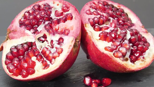 4K - Two halves of a pomegranate. Close-up