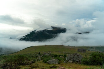 Fototapeta na wymiar Landscape of a cloudy peak of a mountain