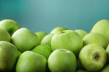 Organic juicy Green apples on a green background.