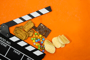 clapper board of video cinema in studio.Movie production clapper board and chocolate candy and bars...