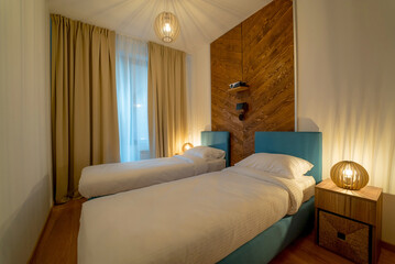 Fototapeta na wymiar Cosy and tidy modern hotel bedroom