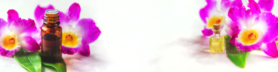 Orchid essential oil in a small bottle. Selective focus.