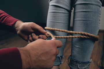 a man bondagely binds a woman